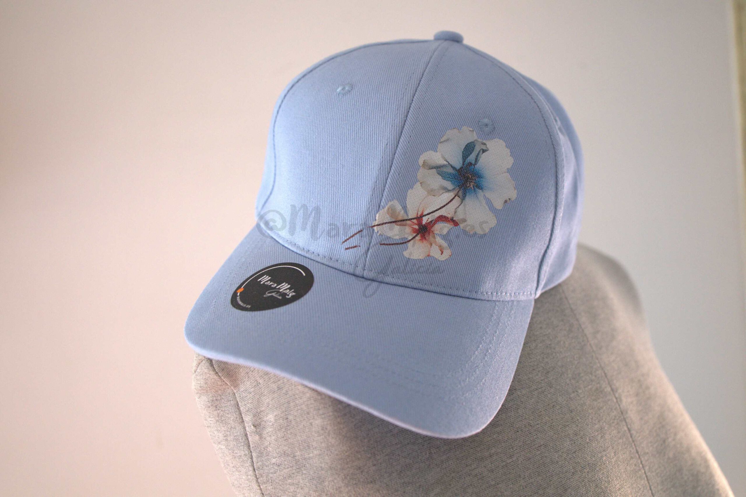 Gorra adulto Minneapolis azul cielo con dos flores, y en visera con logo MaraMalg